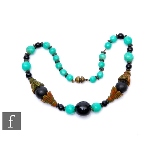 61 - An early 20th Century jadite, black onyx and phenolic chain threaded necklace, weight 72g, length 43... 