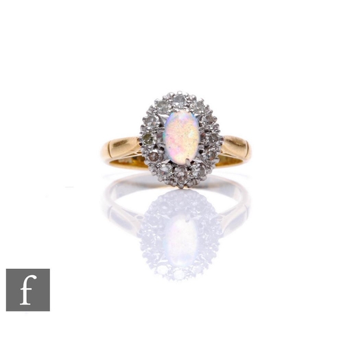 73 - An 18ct opal and diamond cluster ring, central oval opal, length 6mm, within a border of twelve diam... 