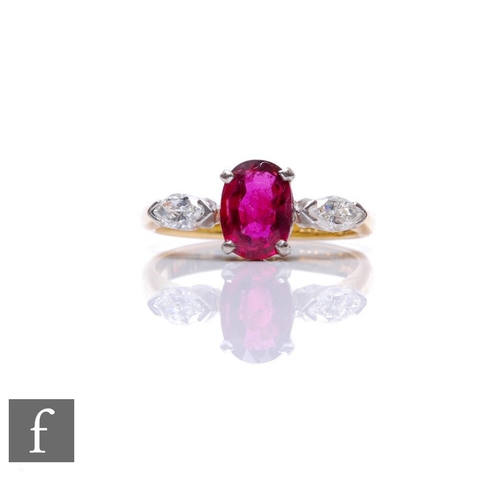 74 - An 18ct hallmarked ruby and diamond three stone ring, central oval ruby, length 7mm, flanked by a ma... 