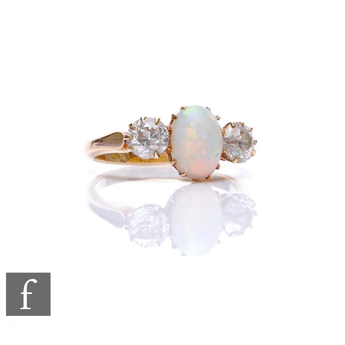 83 - An 18ct opal and diamond three stone ring, central oval opal, length 9mm, flanked by a 0.40ct diamon... 