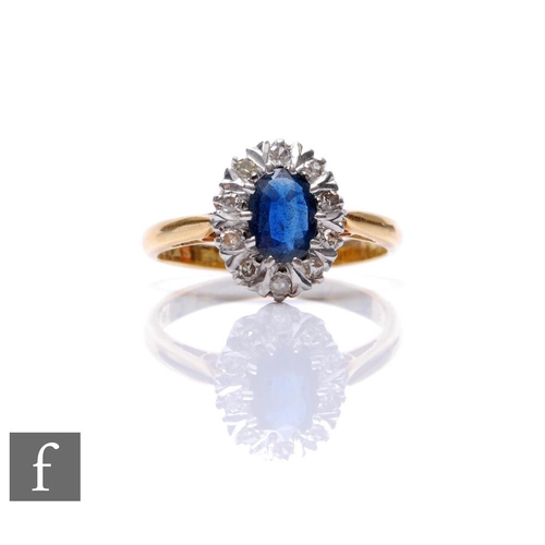 85 - An 18ct hallmarked sapphire and diamond cluster ring, central oval sapphire within a border of ten d... 