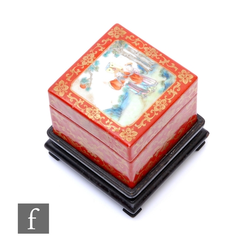 A Chinese Late Qing Dynasty porcelain cosmetics box, the square section box with removable cover and internal turquoise glazed compartmentalized tray, Qianlong seal mark to base, height 6cm, width 7.5cm, raised on a wooden stand.