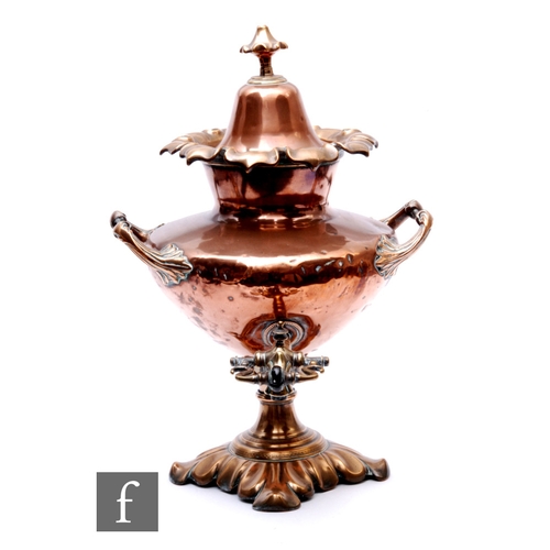 777 - A 19th Century copper two handled samovar of urn form with cover and tap, on a foliate base, height ... 