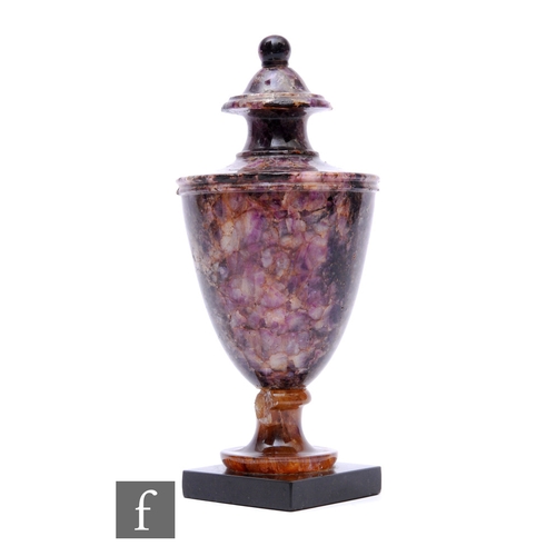 A 19th Century Blue John vase of urn shape, with fixed cover and turned pedestal base, on a slate square plinth base, height 22cm, damaged.