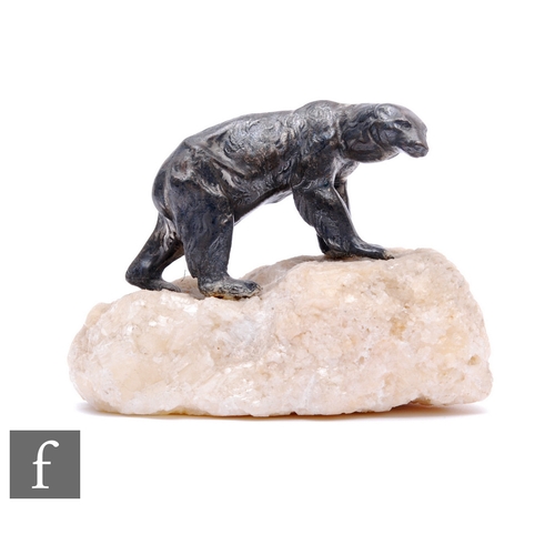 800 - A small 20th Century bronzed Polar Bear standing on a white piece of quartz modelled as an iceberg, ... 