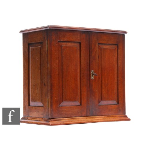 814 - An Edwardian mahogany smoker's cabinet, the interior fitted with two drawers and divisions enclosed ... 