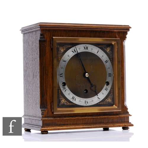 867 - A late 1930s German Elliott oak pillared cased mantle clock with eight day and Westminster and Whitt... 