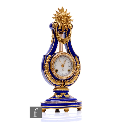 868 - A late 20th Century French Marie-Antoinette gilt metal lute shaped clock, with sunburst mask over a ... 