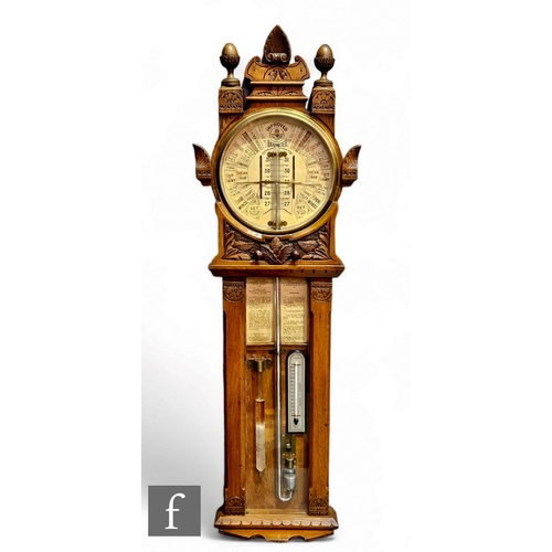 885 - A late 19th century Improved Admiral Fitzroy barometer in carved oak cased with printed circular sca... 