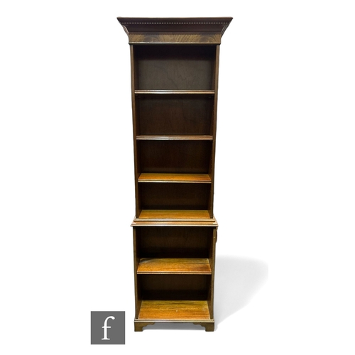 1035 - An Edwardian style mahogany bookcase of narrow proportions, dentil fluted cornice over and adjustabl... 