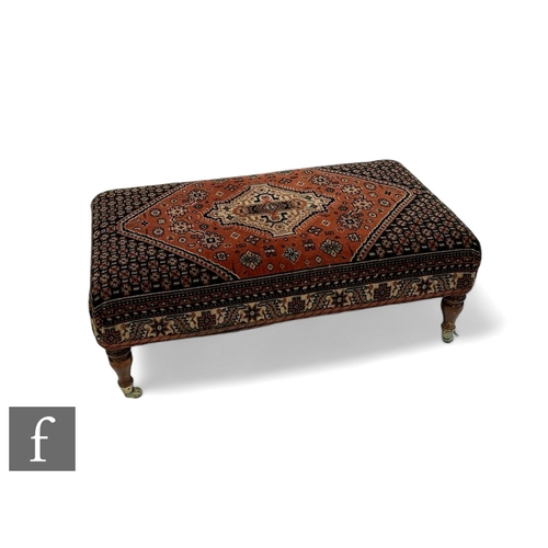 1041 - A large Victorian style stool on turned beech legs, upholstered in a Caucasian rug pattern, width 98... 