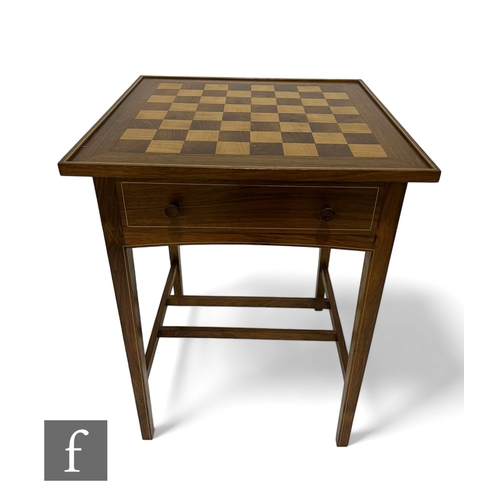 1048 - A late 20th Century bespoke walnut and beech games table, the square chequer board top over a frieze... 