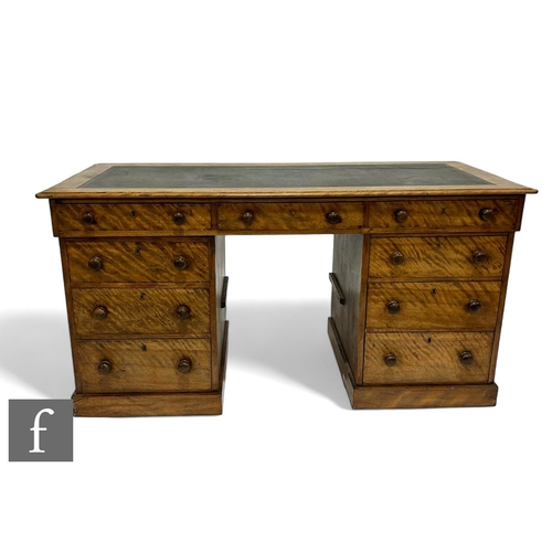 1049 - A Victorian figured mahogany kneehole writing desk fitted with three frieze drawers and three furthe... 