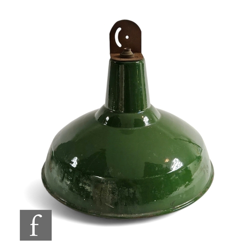 310 - A 20th Century industrial green and white enamelled ceiling light of domed form, height 35cm.