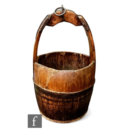 317 - A 19th Century coopered iron bound wooden well bucket with strap and ring attachment, height 66cm.