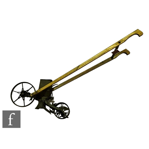 325 - A 19th Century push along seed drill, Planet No 25, iron spoked wheels and elm shaft handles, length... 