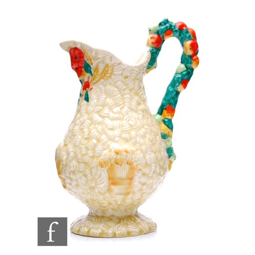 193 - A Clarice Cliff flower jug in Celtic Harvest, the footed baluster form body with high arched handle ... 