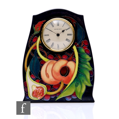 212 - A later 20th Century Moorcroft Pottery mantle clock decorated in the Queens Choice pattern after des... 