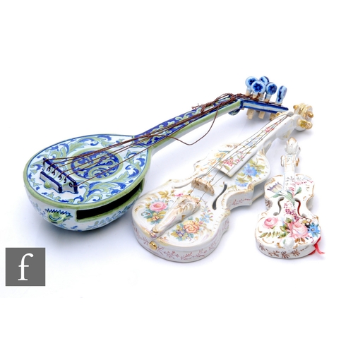 258 - A large early 19th Century Italian Faience ware wall pocket modelled as a stylised lute, decorated w... 