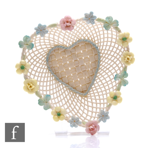 308 - A Belleek heart shaped basket, with ornate flowers to the rim of the basket, applied banner to the b... 