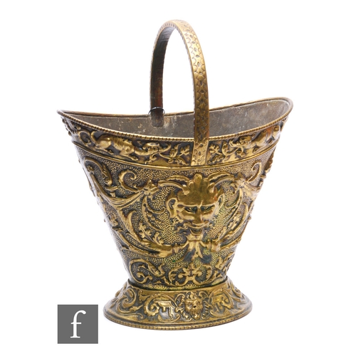 85 - A 20th Century or earlier Renaissance style brass coal bucket with fixed handle, grotesque masks to ... 