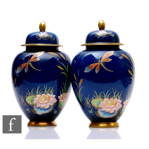 97 - A pair of late 1930s Carlton Ware ginger jars and covers, each of footed ovoid form with domed lids ... 