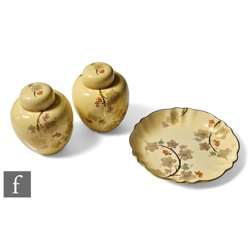 115 - A pair of late 1930s Carlton Ware ginger jars and covers decorated in the Grape Vine pattern with a ... 