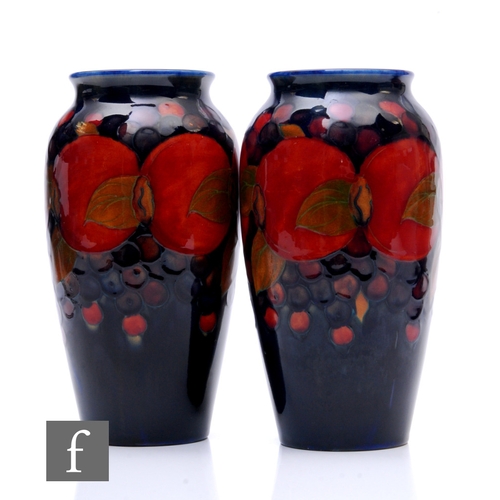 123 - A pair of early 20th Century William Moorcroft Pottery vases of shouldered ovoid form with everted r... 