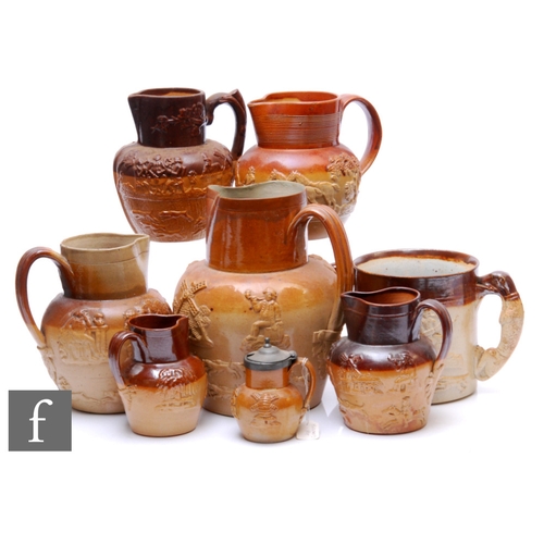 159 - A collection of 19th Century and later salt glazed stoneware jugs with applied sprigged decoration, ... 