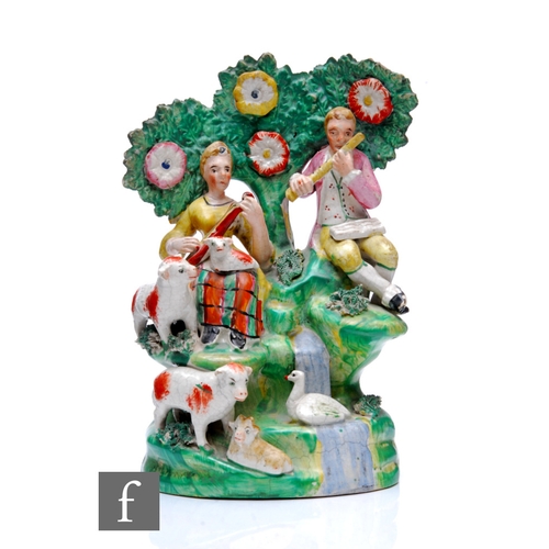 220 - A late 18th to early 19th Century Staffordshire bocage figure group depicting a couple in period dre... 