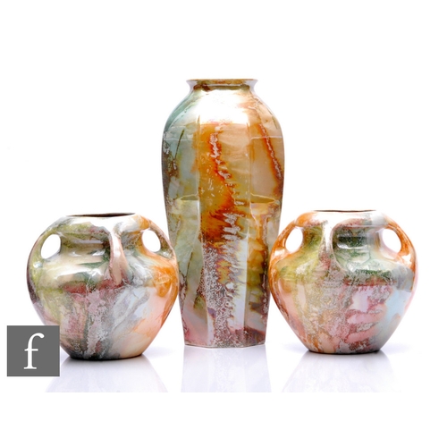 250 - A pair of 1920s Arabia of Finland Art Deco vases, each of low shouldered form with four drawn handle... 