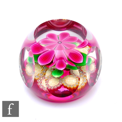 587 - A later 20th Century Perthshire glass paperweight, of domed form with facet cut sides and top, inter... 