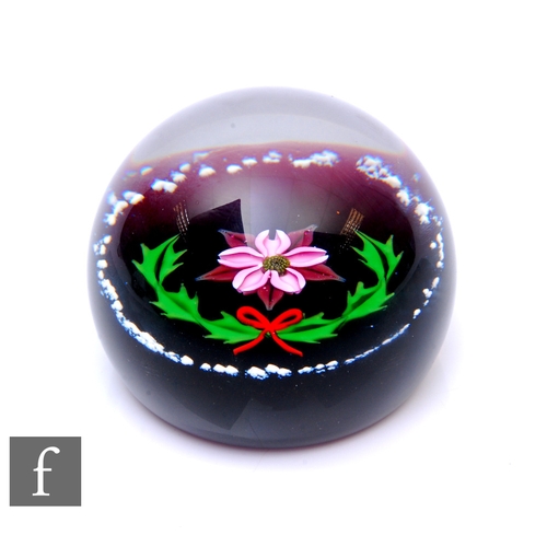 620 - A later 20th Century William Manson for Caithness glass paperweight, of domed form, in the Noel patt... 