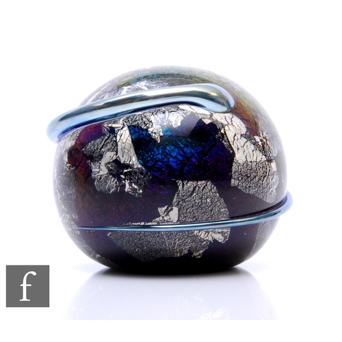 639 - A contemporary Richard P. Golding glass paperweight, of domed form, internally decorated with a gree... 