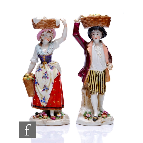 83 - A pair of early 20th Century German hard paste porcelain figures by Sitzendorf, each modelled as fig... 