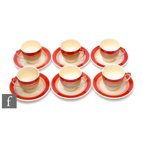 87 - A set of six 1930s Susie Cooper coffee cans and saucers, hand painted with tonal red, brown and grey... 