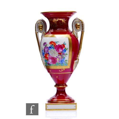 143 - A 20th Century Dresden porcelain vase of footed pedestal form with high arched handles and a flared ... 