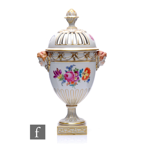 145 - A 20th Century Dresden jar and cover of ovoid form with applied cherub mask handles and acorn finial... 