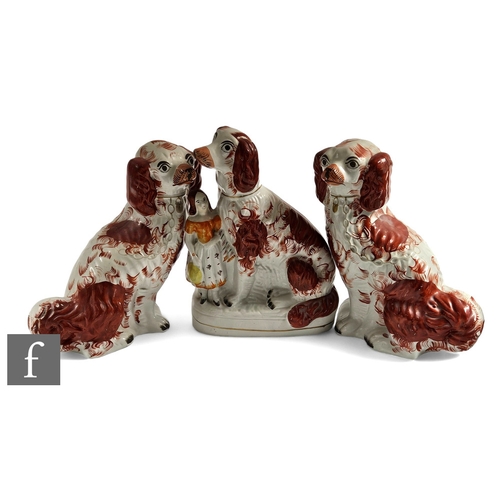 204 - A large pair of 19th Century seated Staffordshire Spaniels picked out in rust red flash with gold pa... 