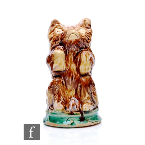 253 - A 19th Century ceramic pounce pot in the form of a seated bear with pour holes to the top of the hea... 