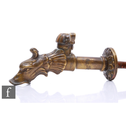 148 - An Edwardian brass tap with medieval stylised spout in the form of a beast's head, width 18cm.