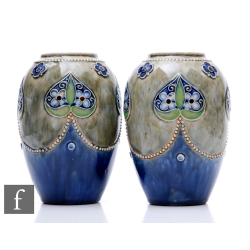 78 - A pair of early 20th Century Royal Doulton stoneware vases of ovoid form, relief decorated with styl... 