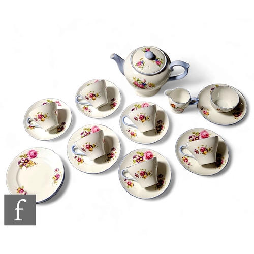 100 - A Shelley New Cambridge shape teaset decorated with a floral spray including roses and blue banding,... 