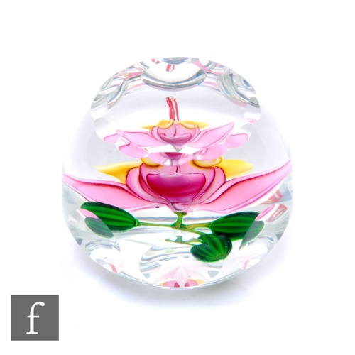 591 - A late 20th Century Perthshire glass paperweight, of domed form with facet cut sides and top, intern... 