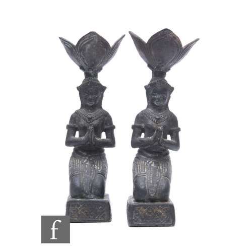 190 - A pair of 20th Century Indian bronze candlesticks modelled as two kneeling praying figures, height 1... 