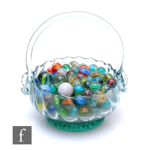 202 - A collection of marbles and a glass basket.