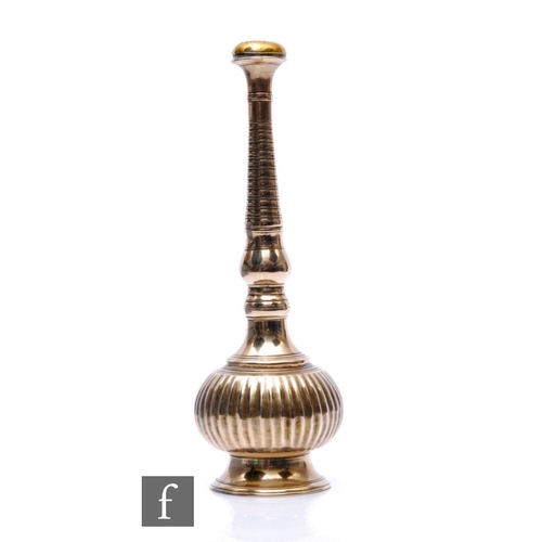 363 - A bronze rose water sprinkler, spread foot below fluted bulbous base rising to a tapering ring neck ... 