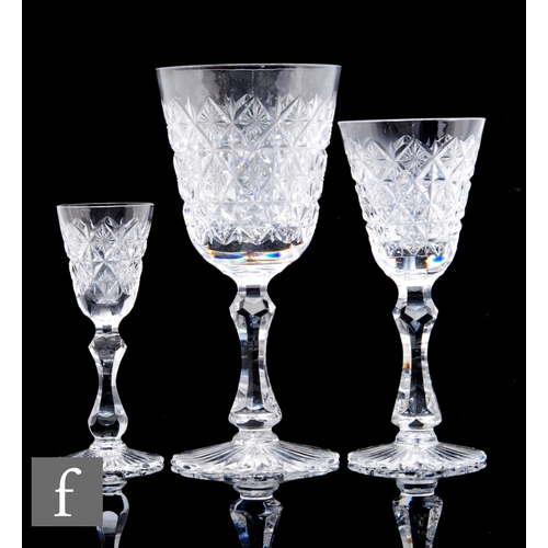 486 - A 20th Century suite of Stourbridge drinking glasses, each with round funnel bowl engraved with star... 