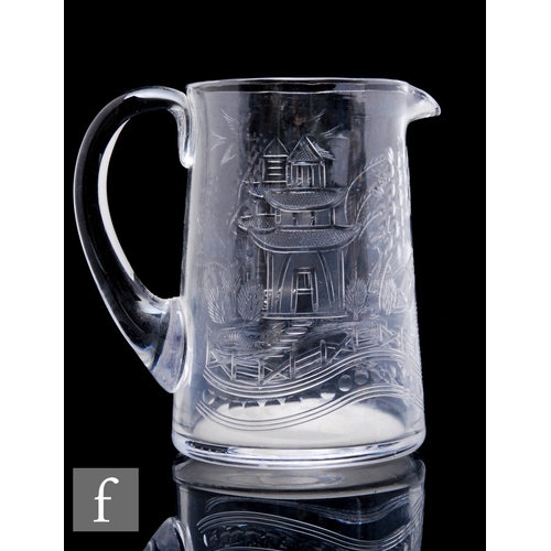 507 - A Stevens & Williams clear crystal cream jug engraved in the Willow pattern, height 15cm.