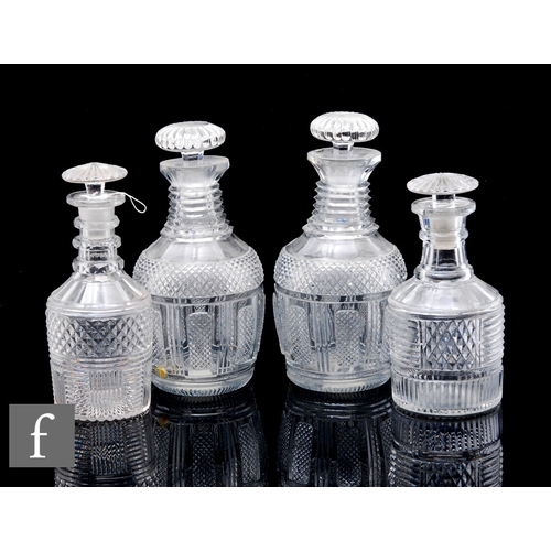 538 - A pair of 19th Century glass decanters of Prussian form, each cut in the Regency manner with panels ... 